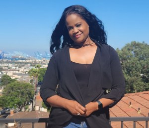 Woman in front of blue sky.
